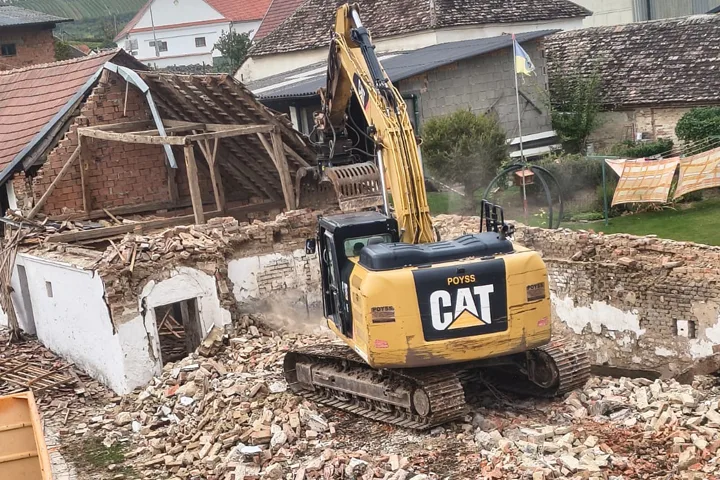 Bagger beim Abbruch eines alten Bauernhauses
